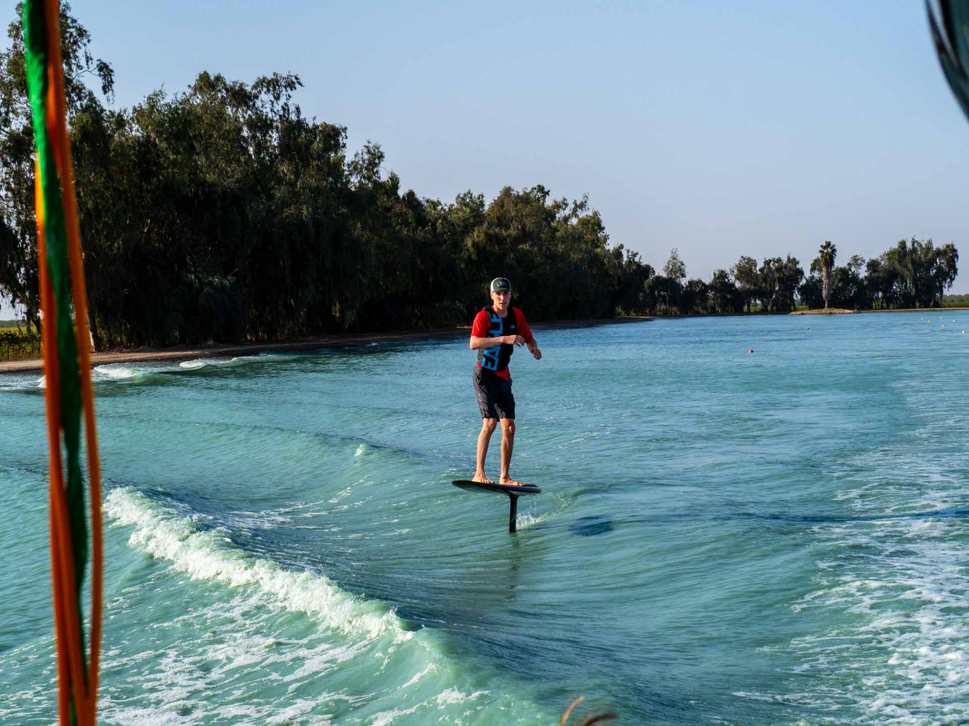 Wake surf foiler riding the second roller